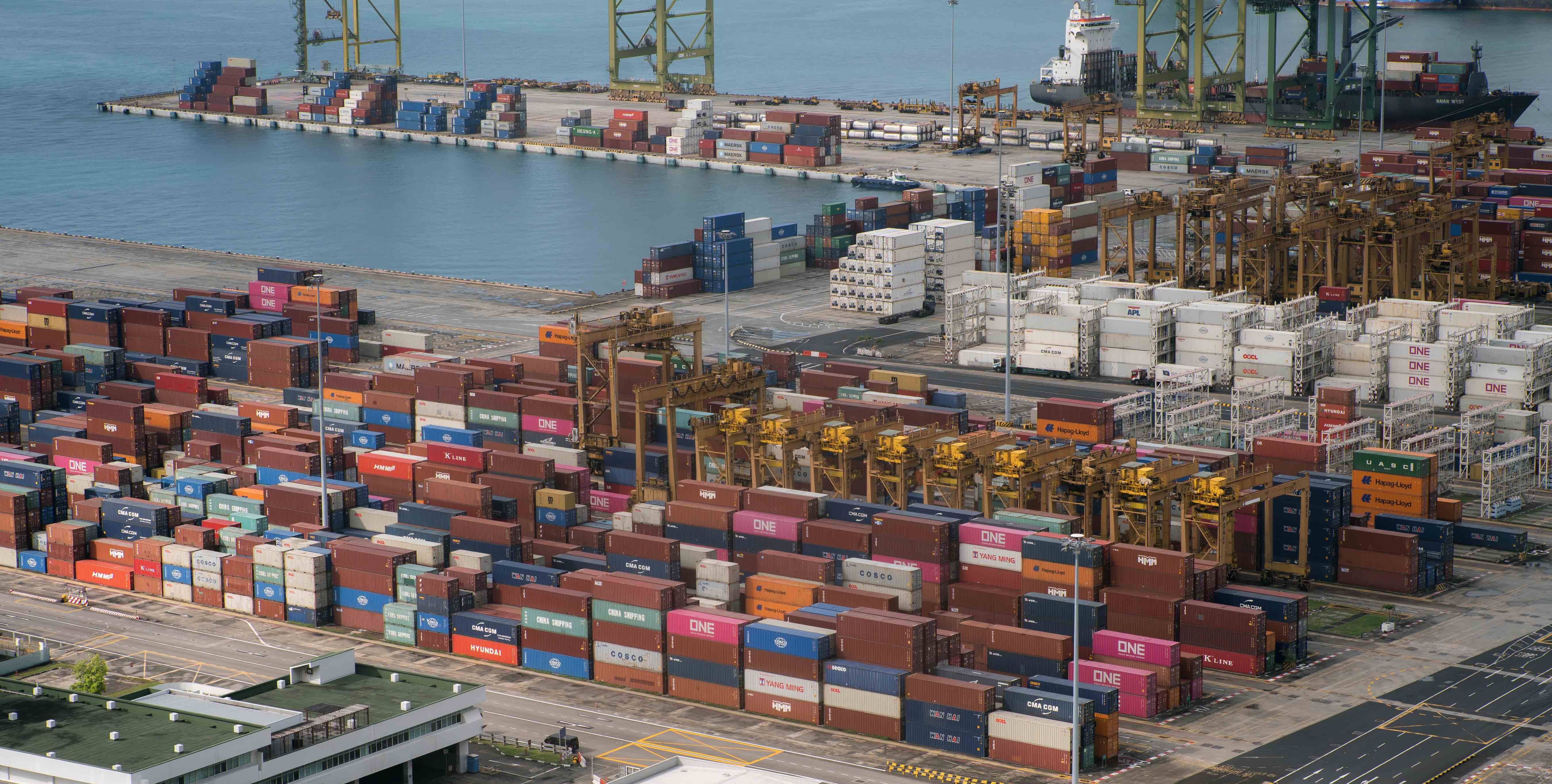 Aerial view of industrial port filled with colourful shipping containers from MAS rooftop